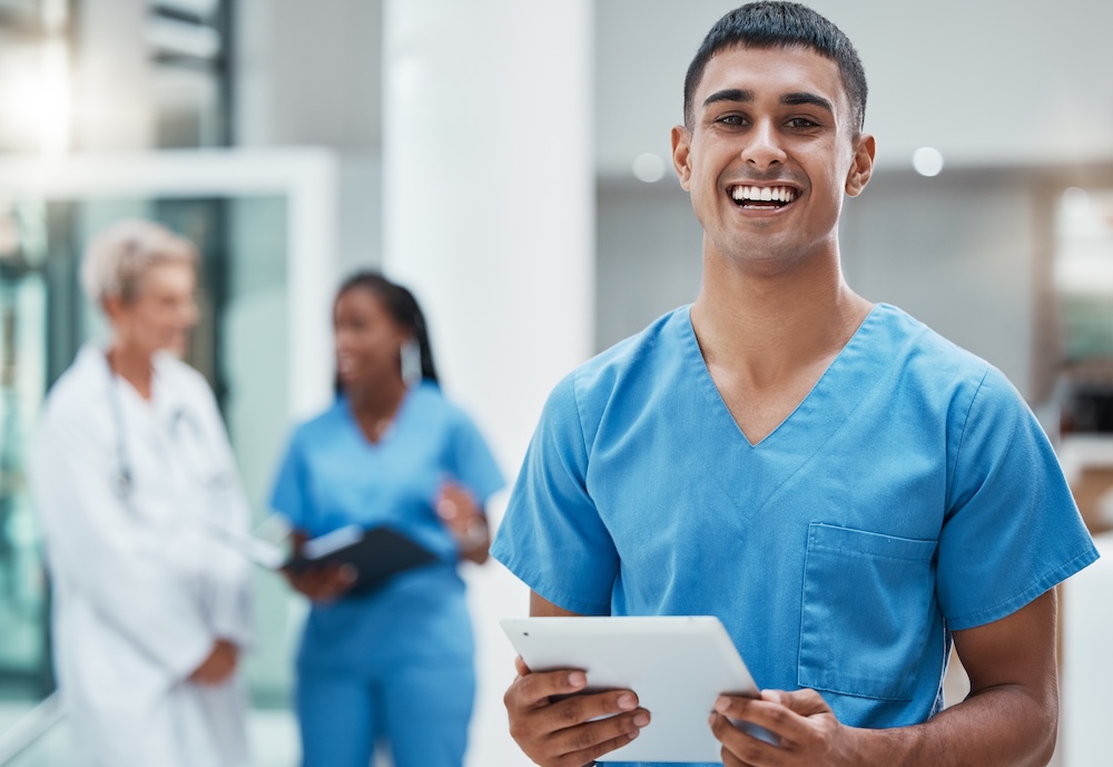 Tablet, healthcare and medicine with a man nurse doing research in a hospital for health or treatment. Medical, insurance and medicare with a young male clinic worker doing a search online